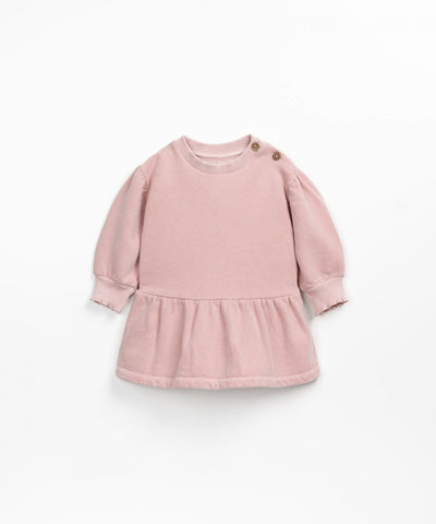 long sleeve baby girl dress pink color. big peplum ruffle at the bottom of the dress