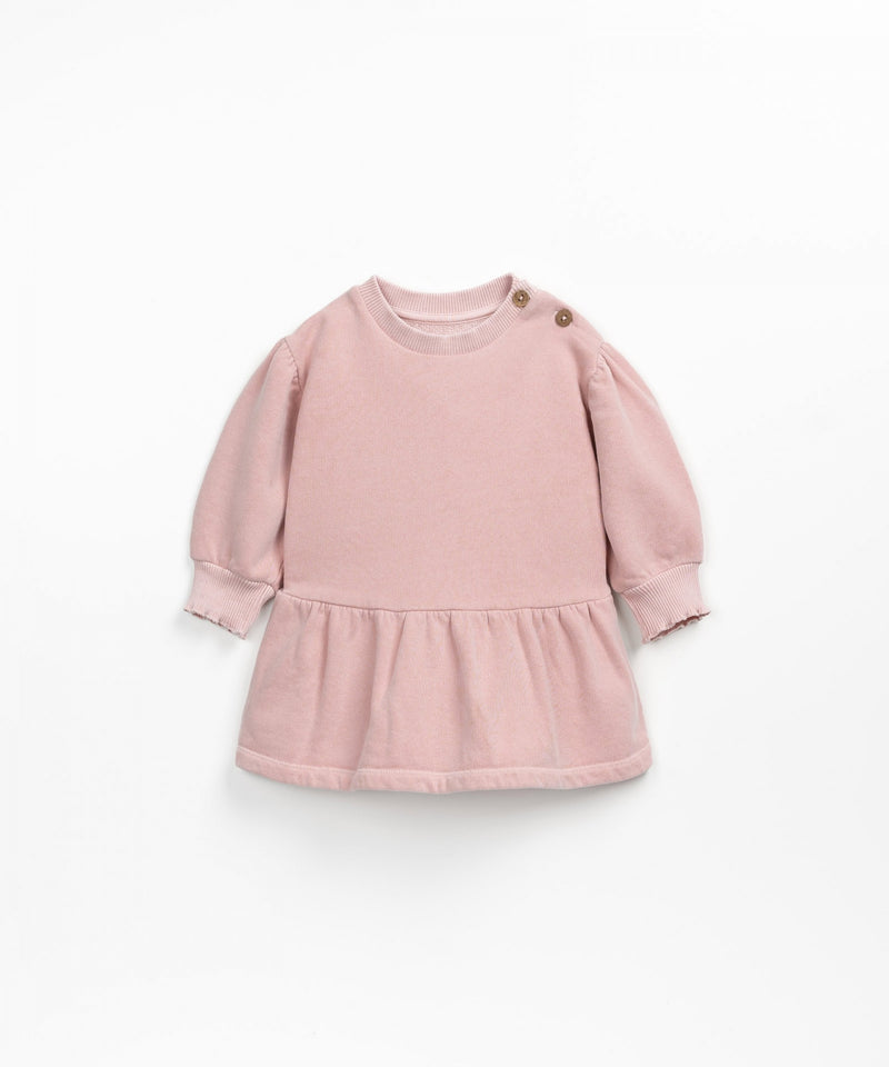 long sleeve baby girl dress pink color. big peplum ruffle at the bottom of the dress