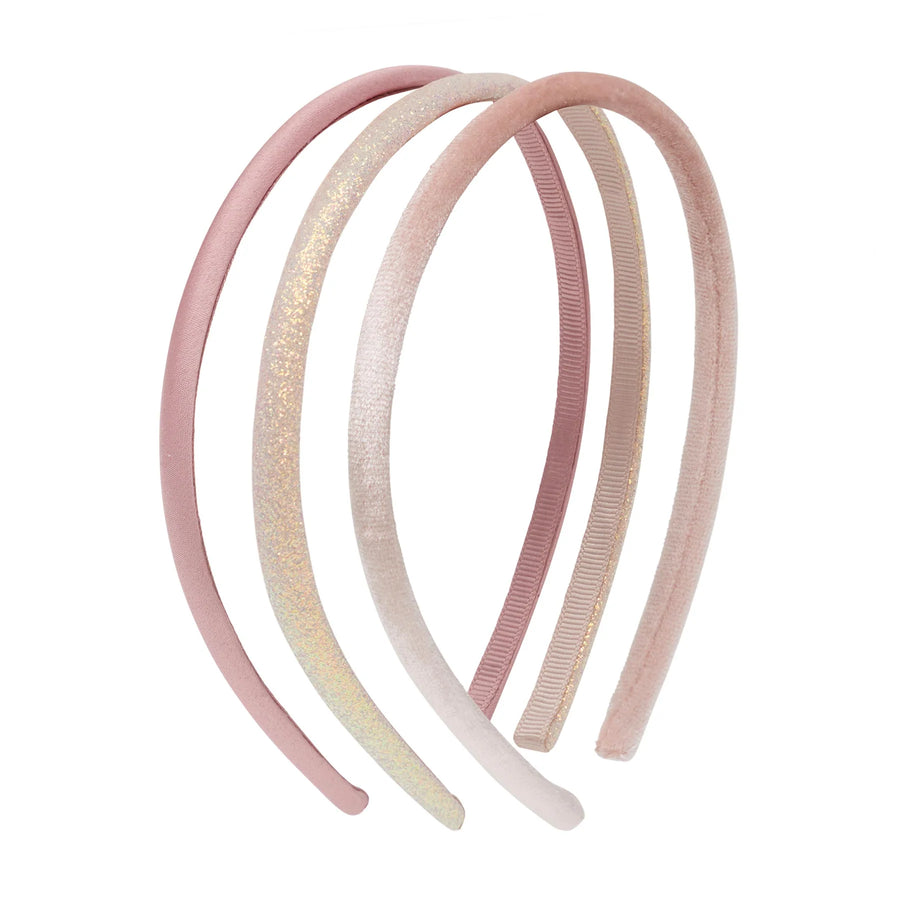 three pink and blush headbands arranged overlapping on a plain white background, including one glittery headband and three ribbed headbands.