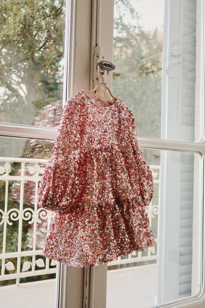 This picture shows the dress hanging on a hanger in natural light. the pink is stunning looks more like a rose gold. 