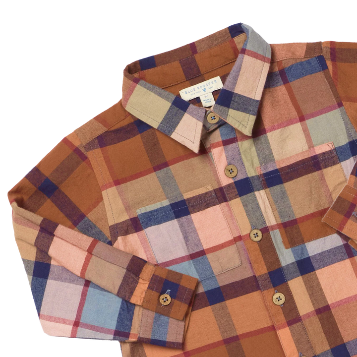 close up of the rust color plaid shirt 