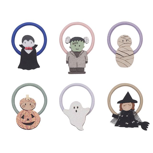 Set of Halloween-themed hair ties with characters including a witch, ghost, and mummy on a white background.