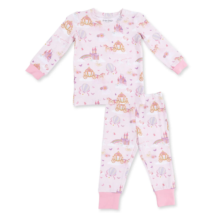 A two-piece children's pajama set by Princess Design, featuring a long-sleeve top and matching pants in light pink with an all-over whimsical print of castles, carriages, and hot air balloons, finished with solid pink cuffs.