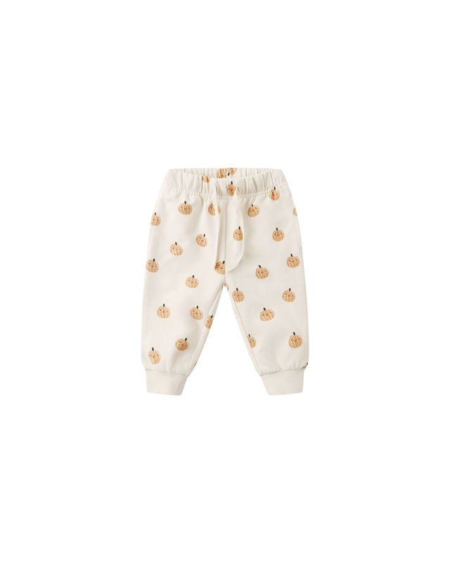 beige baby pants with pumpkin pattern on a white background