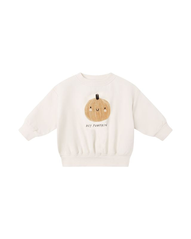beige sweatshirt with a pumpkin graphic and text on a white background