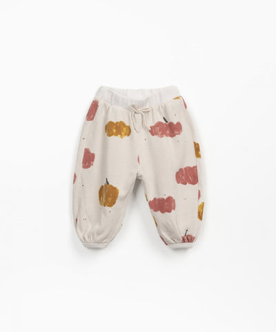 beige sweatpants with pink and gold  pumpkins all over 