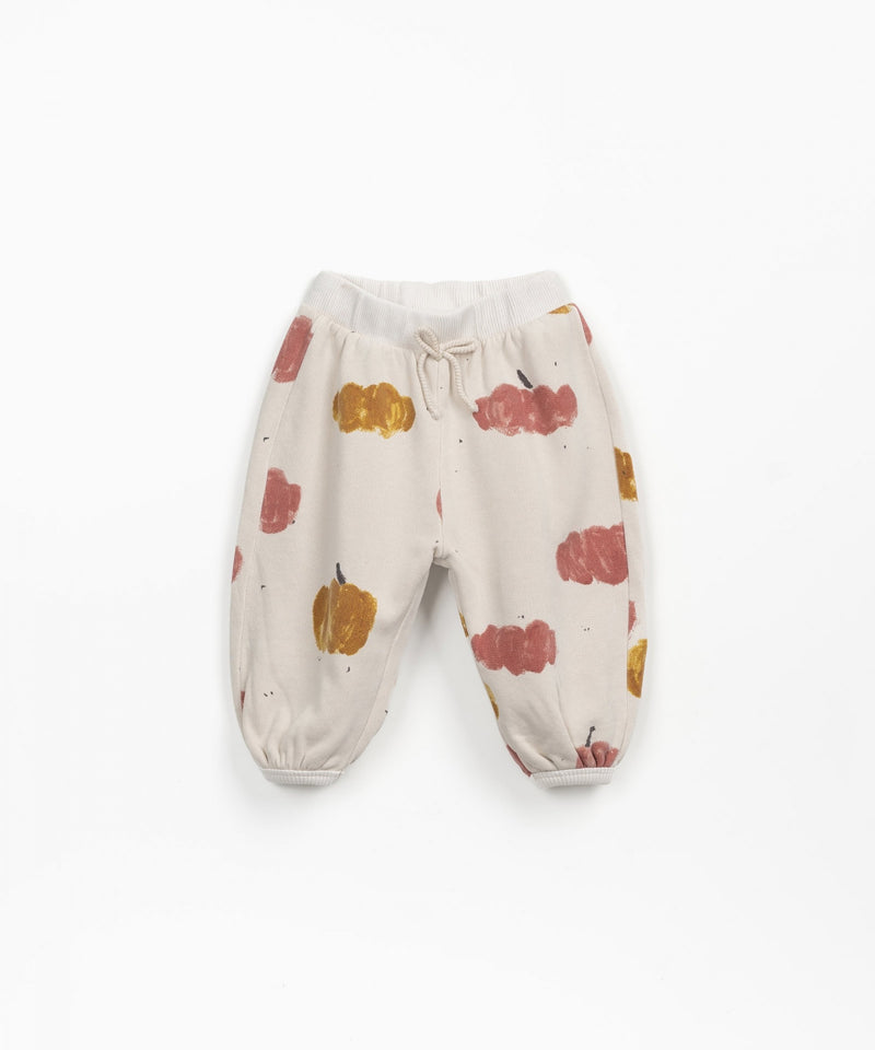 beige sweatpants with pink and gold  pumpkins all over 