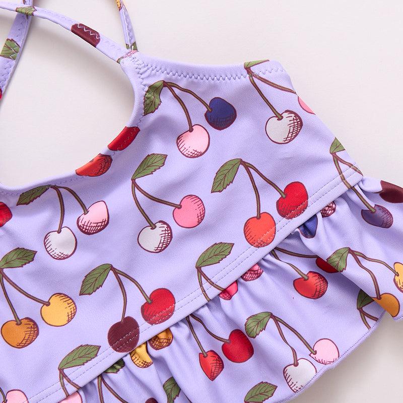 close up picture of the cherry print. lavender color with multi color cherries and ruffle bottom top. 