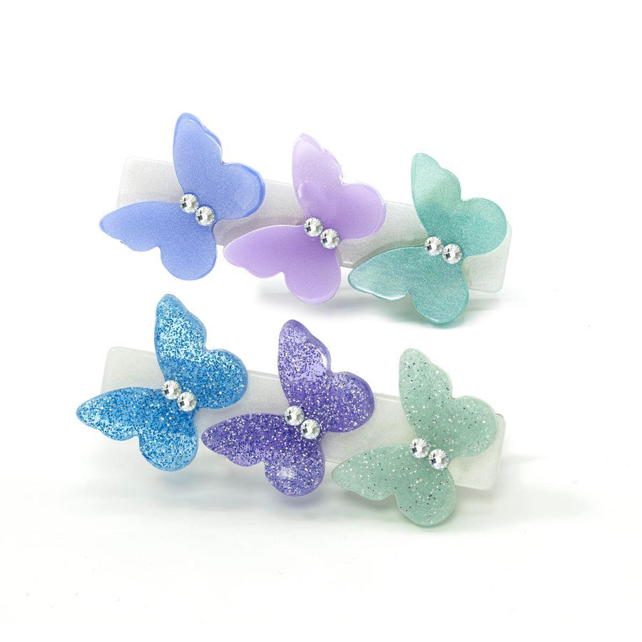 Set of 2 alligator clips each with 3 butterflies: blue, lavender, green- one clip the butteflies are glittery and the other they are pearlized. 
