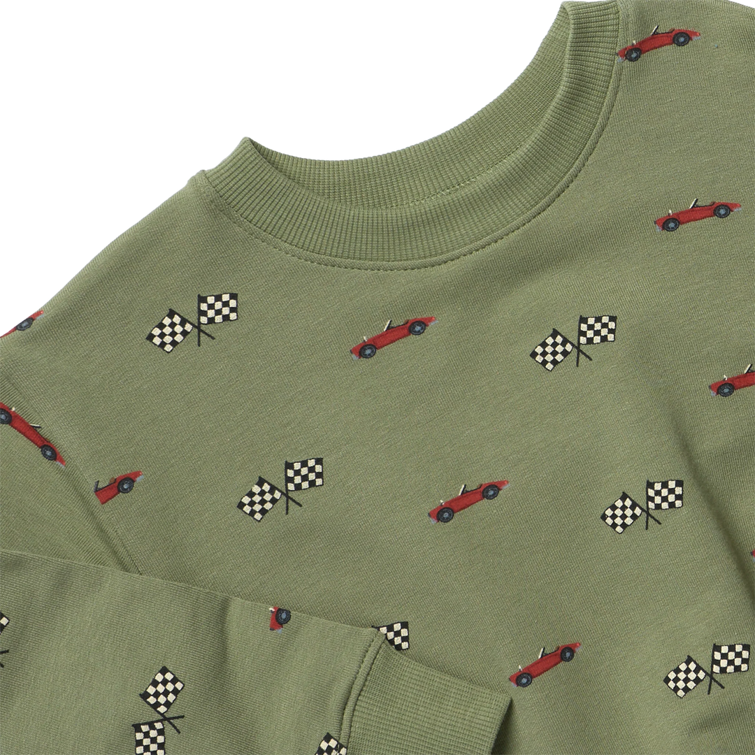 An olive green crewneck sweatshirt featuring a repeating pattern of red race cars and black-and-white checkered flags, shown on a plain white background.