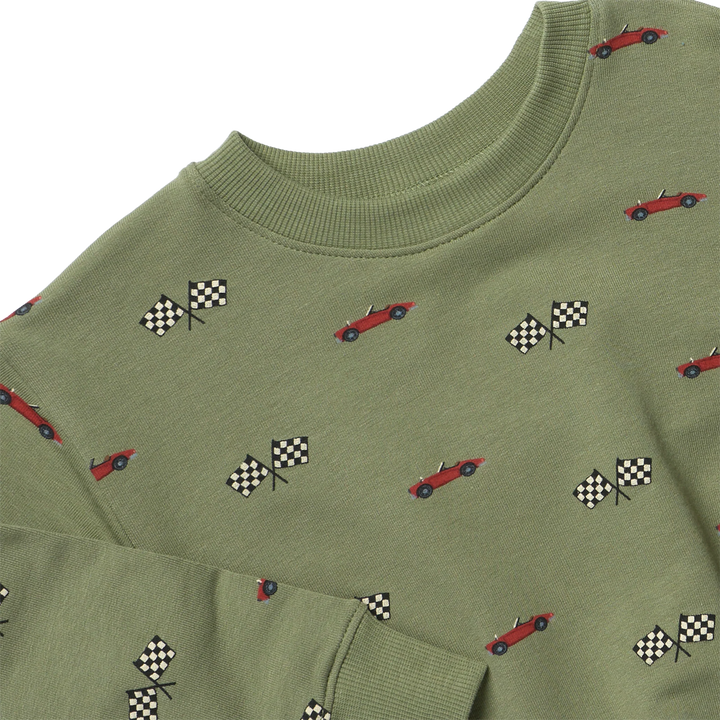 An olive green crewneck sweatshirt featuring a repeating pattern of red race cars and black-and-white checkered flags, shown on a plain white background.