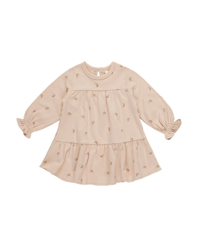 beige baby girl dress with neutral colored rainbows all over the dress. long sleeve 