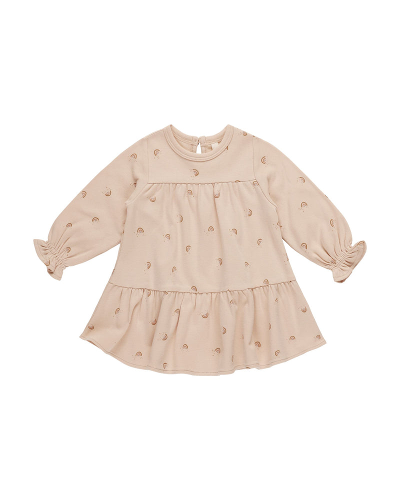 beige baby girl dress with neutral colored rainbows all over the dress. long sleeve 