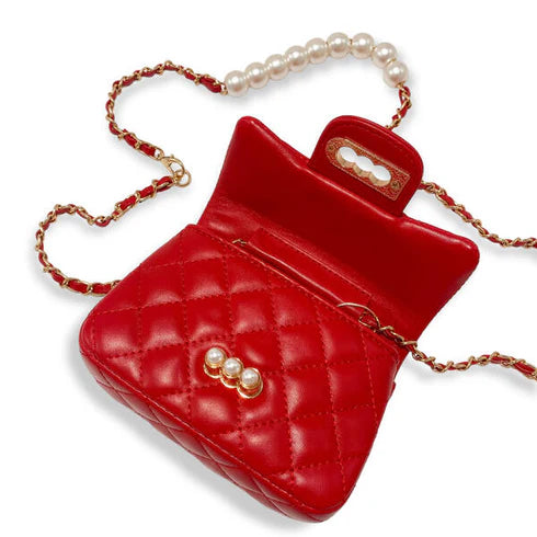 Red quilted handbag with pearl embellishments on a white background