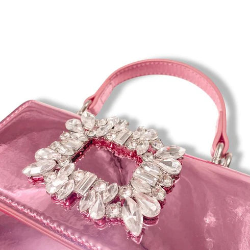 Metallic Pink handbag with a decorative rhinestone with a handle