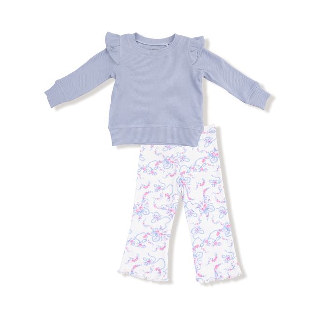 Children's outfit with light blue sweatshirt and floral pants on a white background