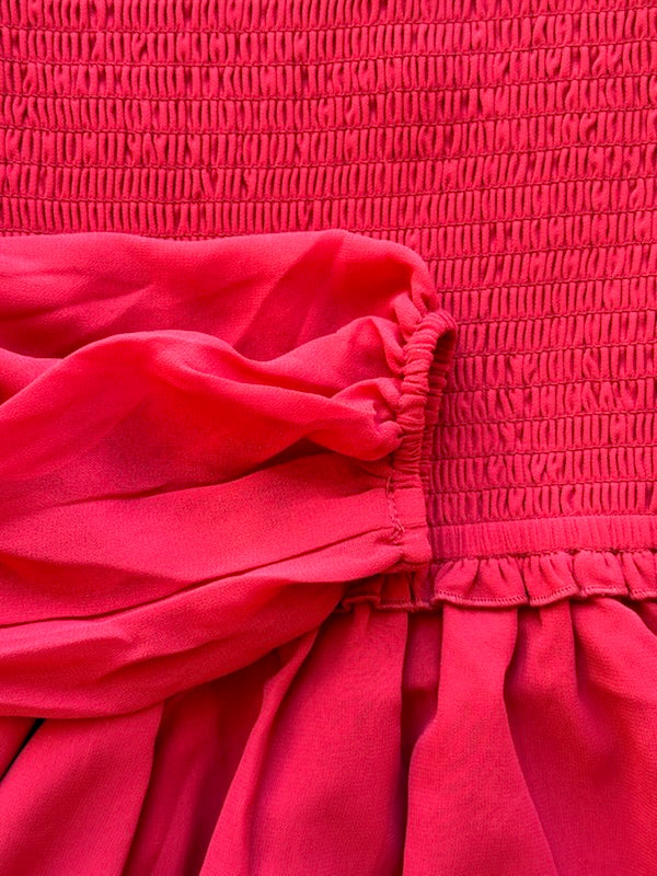 Close-up of a red textured fabric with a focus on texture and color.