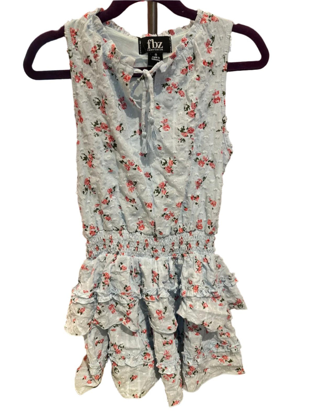 girls dress light blue with tiny pink rosebuds all over it. elastic waistband and tiered ruffle skirt and tie at the neck. 