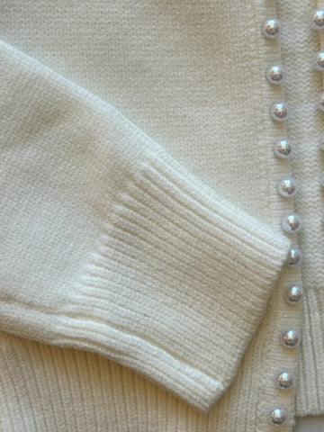 close up of the sleeve and the edge pearl detail of the cardigan
