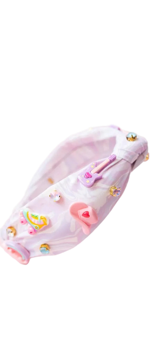 Music City Charm Knot Headband with lilac swirl pattern on a pink background