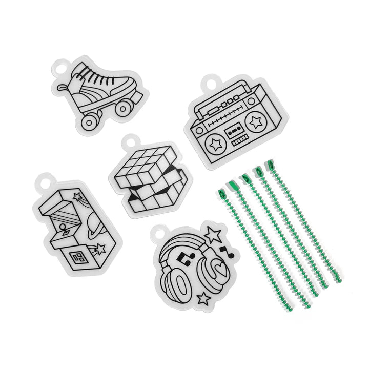 Set of black and white charms with green beads on a white background
