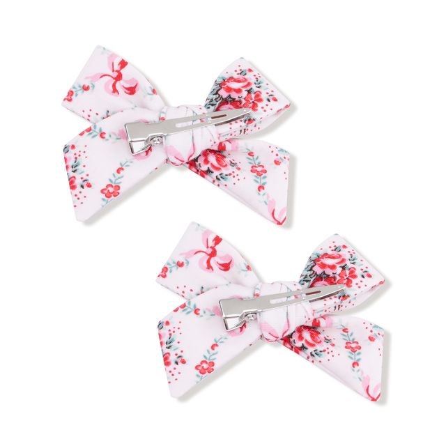 Two floral hair bows with clips on a white background
