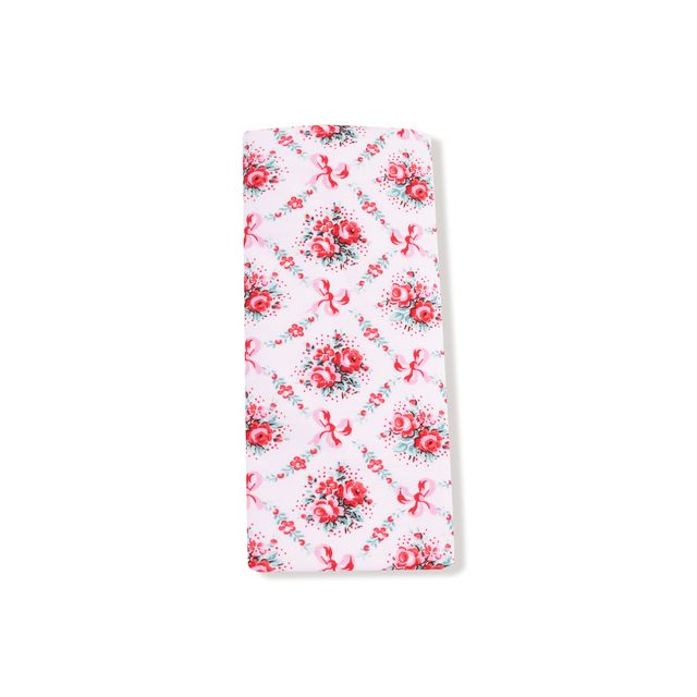 Floral patterned burp cloth with pink flowers and green leaves on a white background