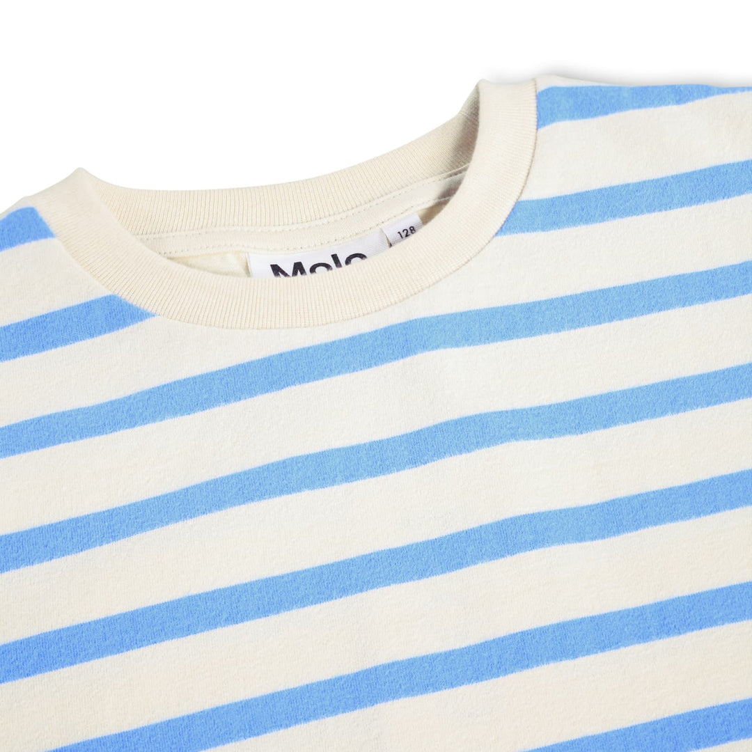 Close-up of a blue and white striped shirt with a brand label.