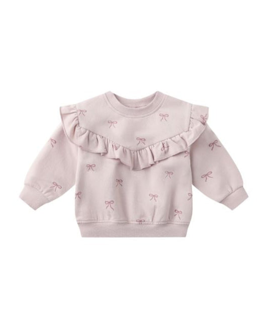 Pink baby sweater with ruffles and bow patterns on a white background