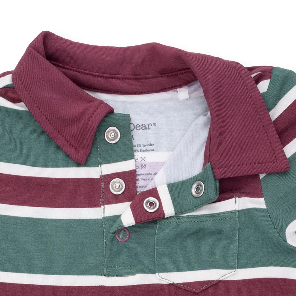 Close-up of a children's polo shirt with a burgundy collar and placket, green and white horizontal stripes, and silver snap buttons on a white background.