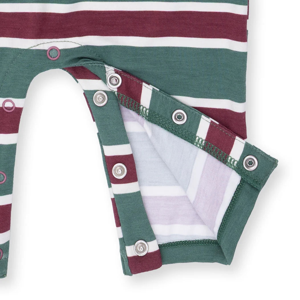 Close-up of a folded fabric with green, red, and white stripes on a white background