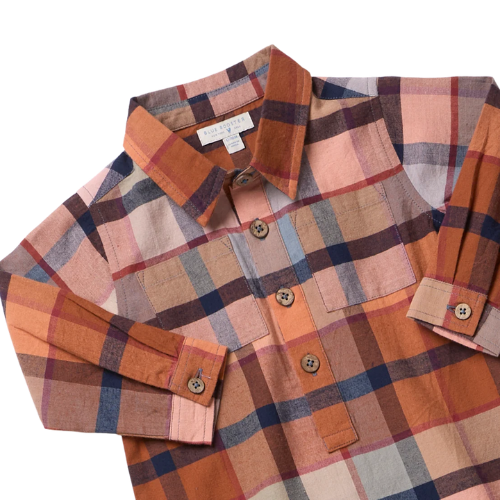 close up of the fabrication and style in a rust plaid with blue accents. 