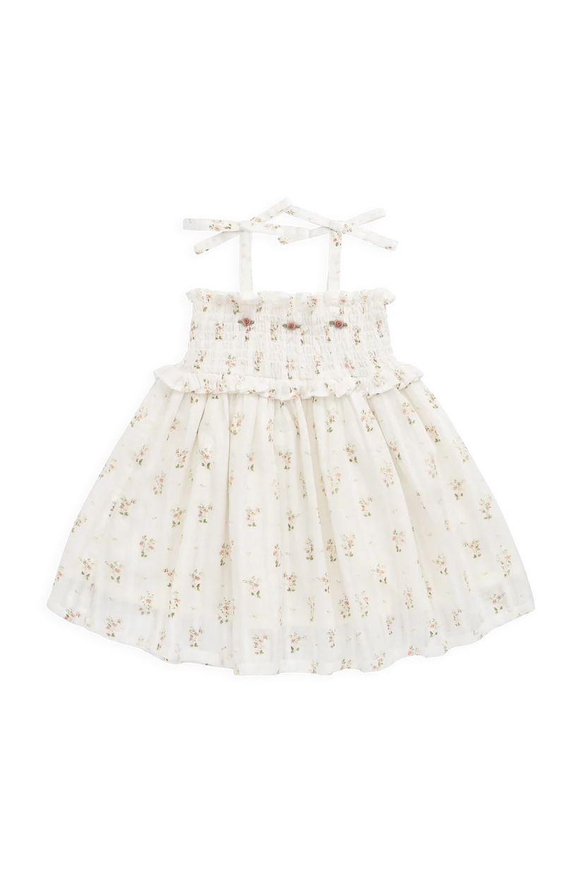 White dress with floral embroidery on a white background