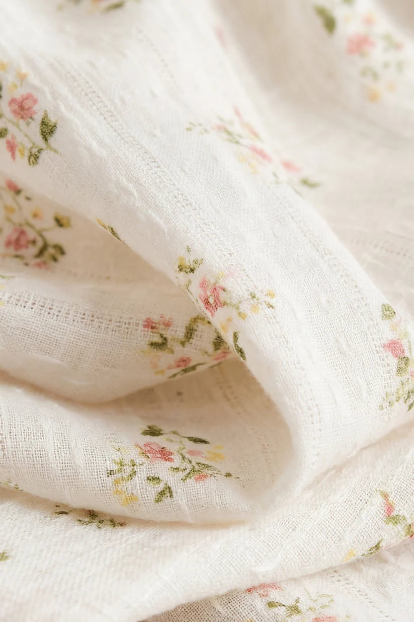 Close-up of white fabric with small floral patterns