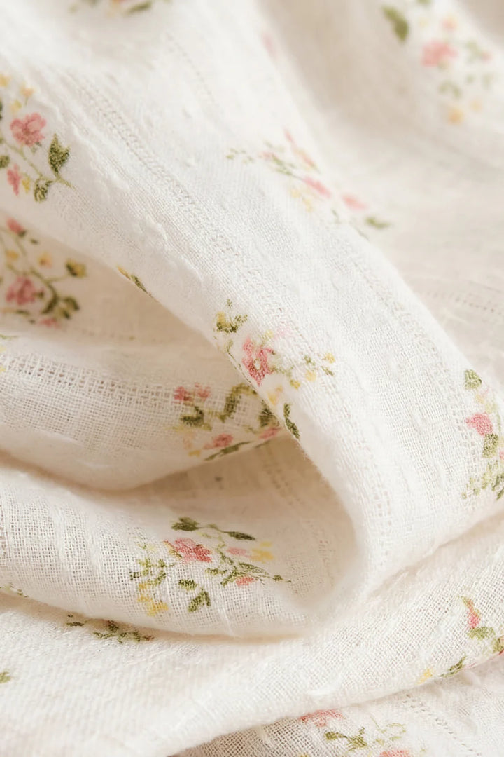Close-up of white fabric with small floral patterns