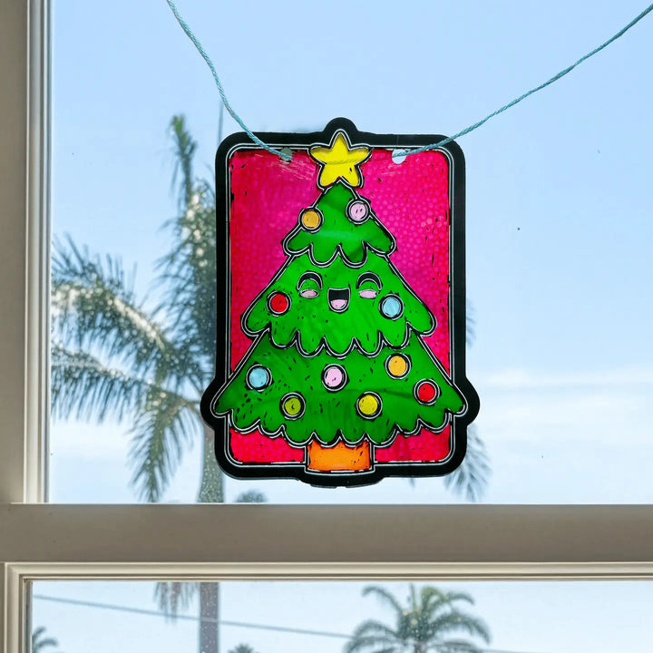 Decorative stained glass Christmas tree hanging on a window