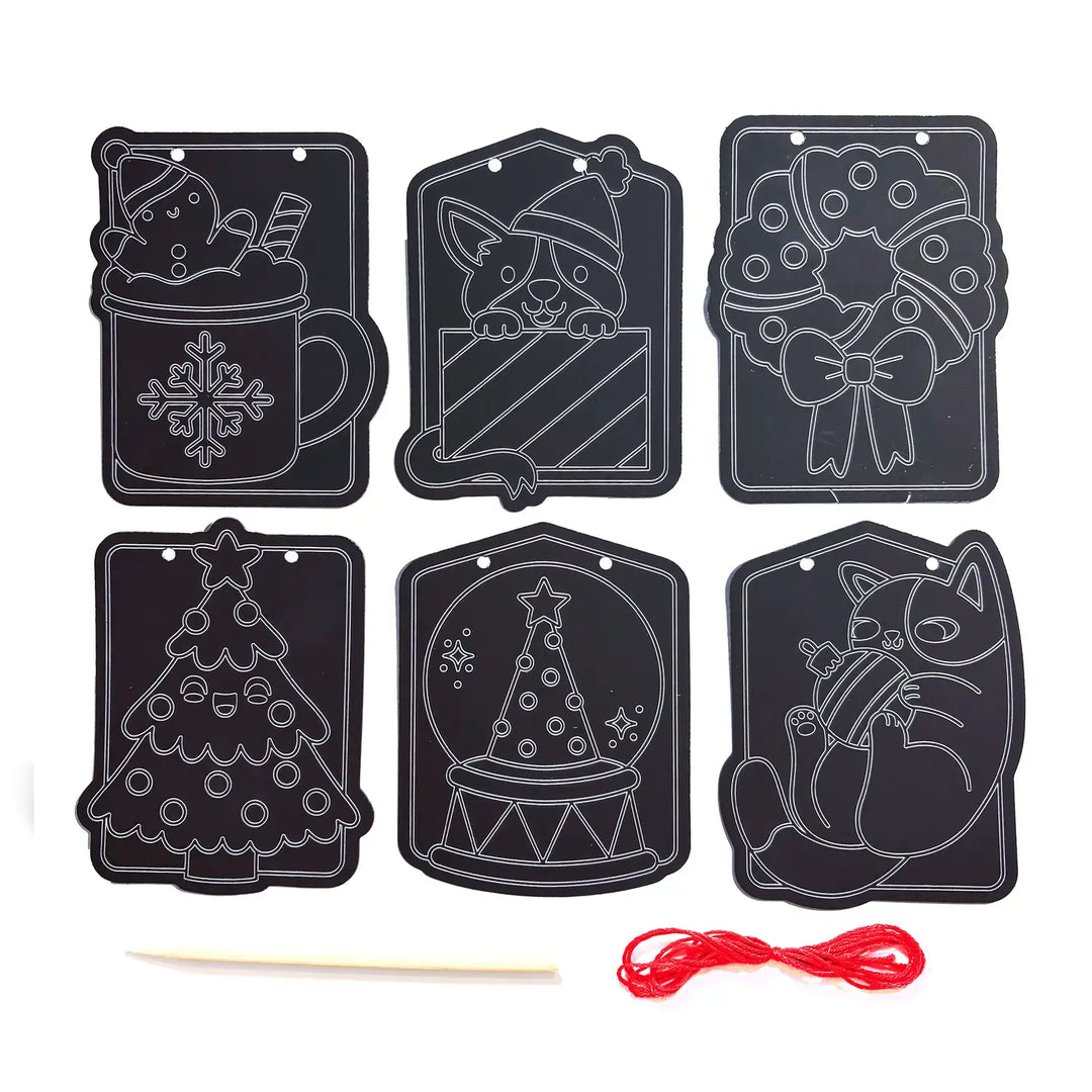 Set of black Christmas-themed scratch art tags with a wooden stick and red string on a white background.