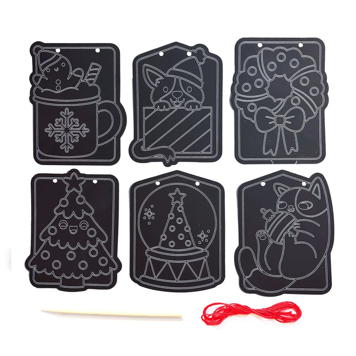 Set of black Christmas-themed scratch art tags with a wooden stick and red string on a white background.