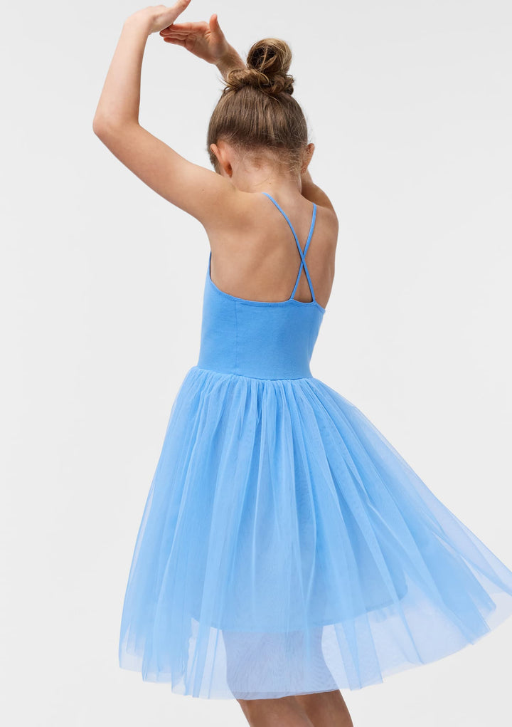 Child wearing a light blue dress with thin straps on a plain background