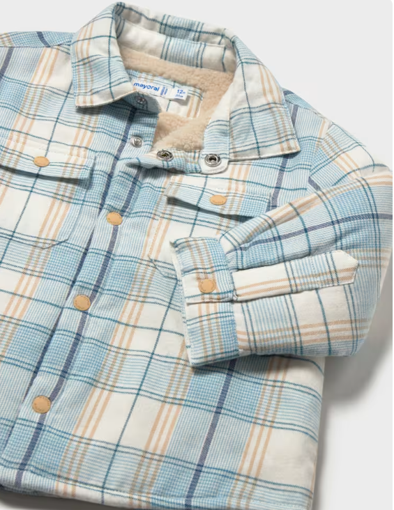 A close-up of a plaid button-front shirt jacket with a light blue, beige, and white pattern, featuring a soft fleece lining visible inside the collar and a buttoned cuff.