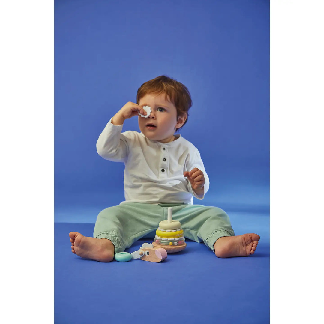 Child playing with toys on a blue background