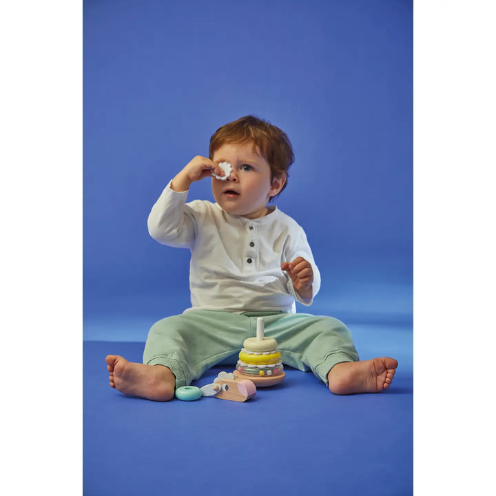 Child playing with toys on a blue background