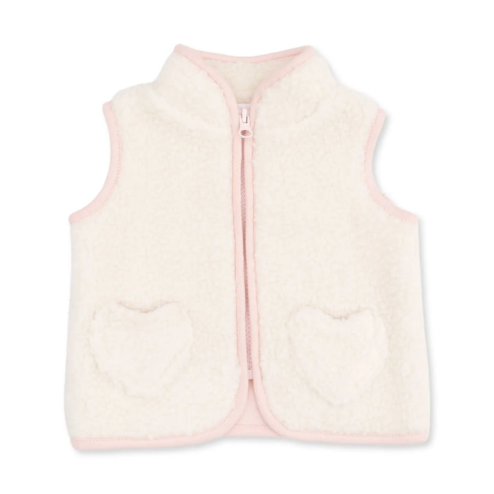 A cream-colored sherpa fleece vest with light pink trim, featuring a front zipper and two heart-shaped pockets on the front.