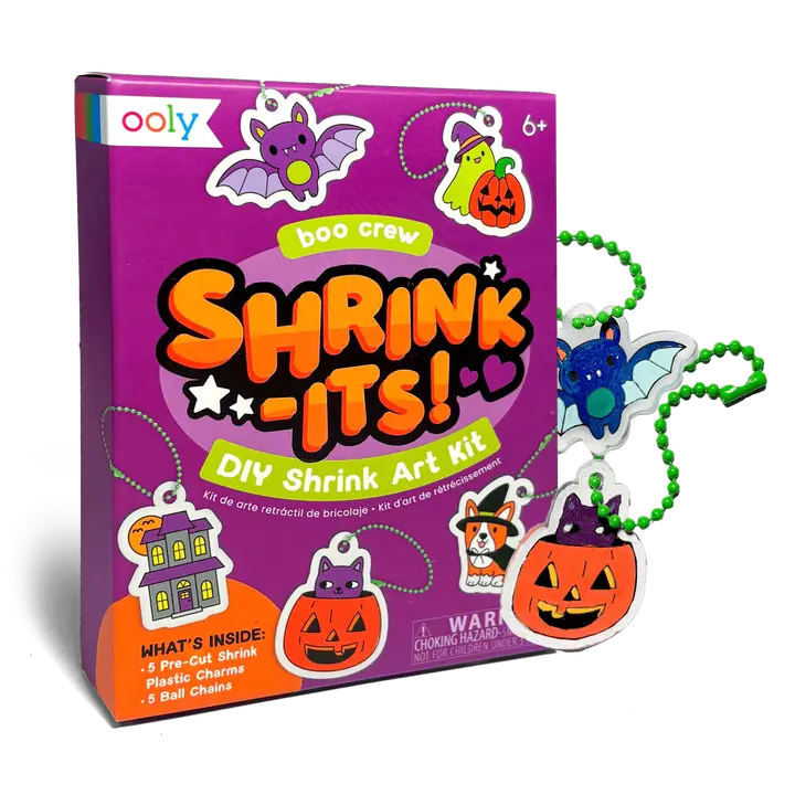 Ooly Boo Crew Shrink-Its! DIY Shrink Art Kit box shown with several small Halloween-themed plastic crafts attached to green bead chains on a white background.