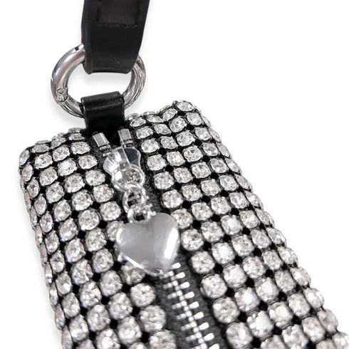 Handbag with rhinestone embellishments and a heart charm on a white background