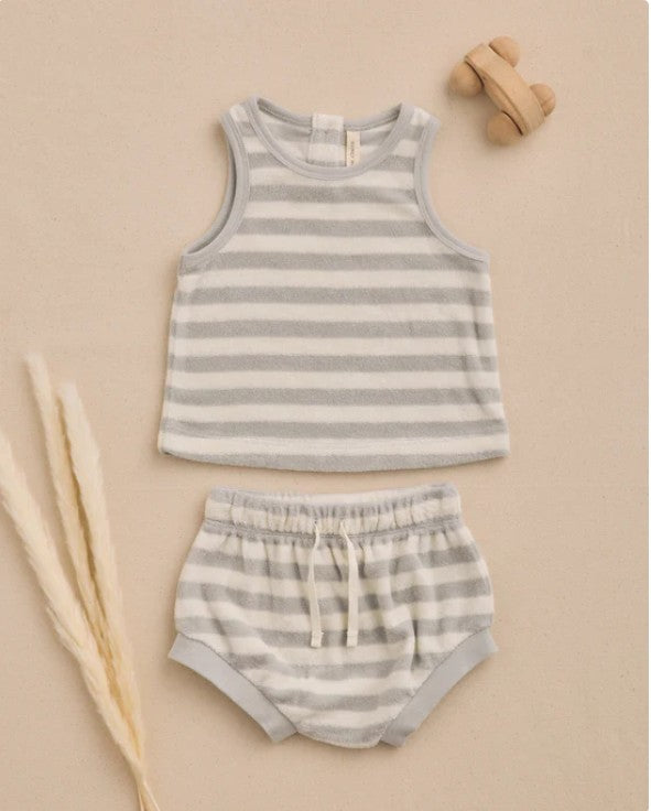 Striped tank top and shorts set on a beige background