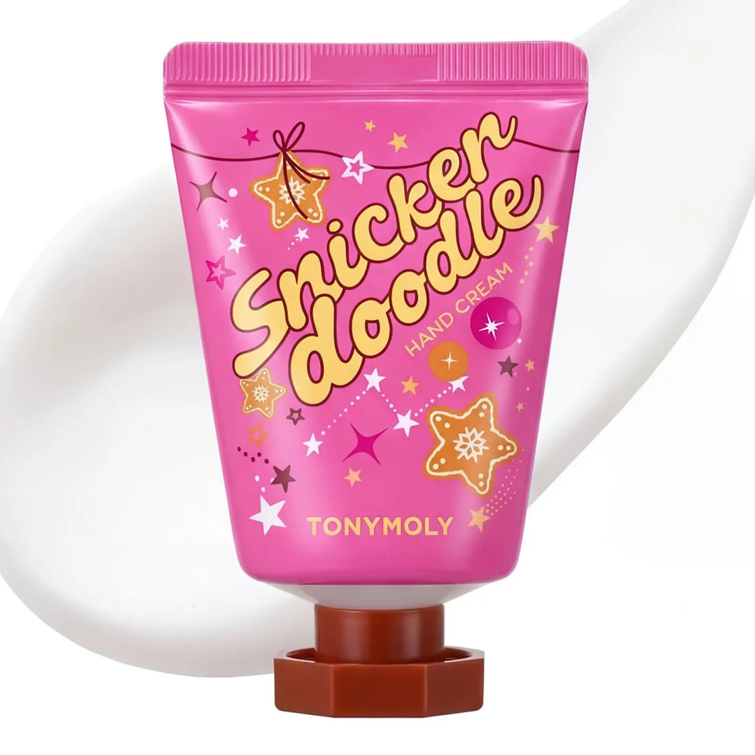 A tube of TONYMOLY Snicker Doodle Hand Cream in a vibrant pink packaging with gold and white lettering, decorated with star and cookie graphics, set against a white background with a soft shadow.