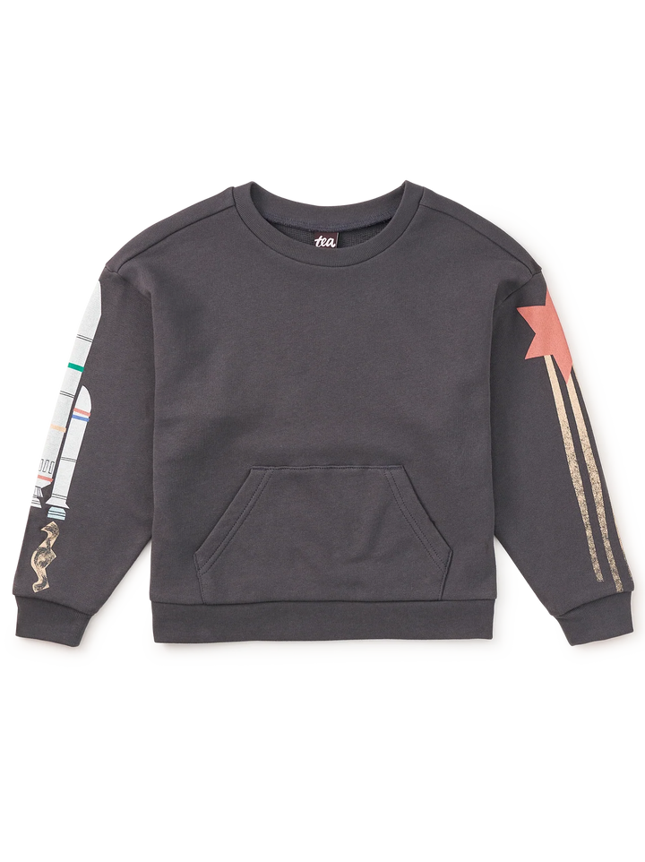 A dark gray crewneck sweatshirt with a kangaroo pocket, featuring a rocket graphic on the right sleeve and a pink star with gold stripes on the left sleeve, laid flat on a white background.