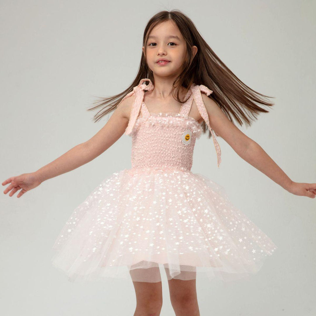 young girl modeling the tulle dress twirling around. 