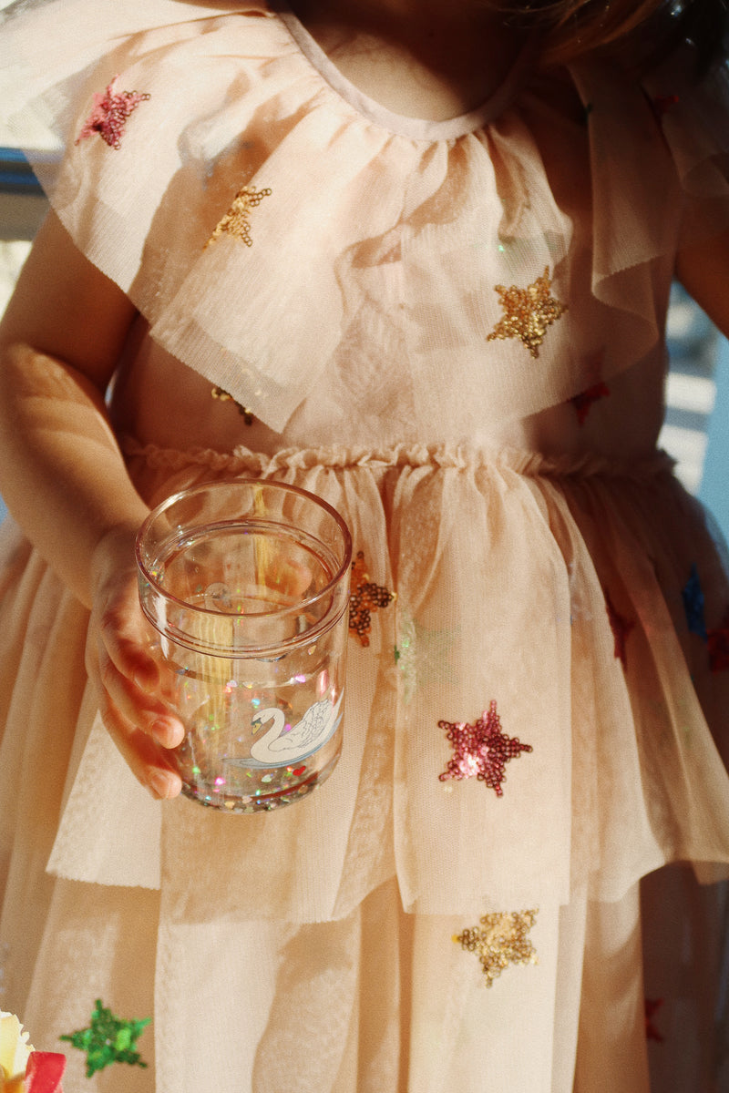 a dreamy shot of the dress in low light, beautiful shot of the dress and the way it hits the little girl wearing it. 